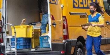trabalhadores descarregando encomendas do correios