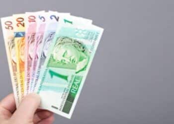 Pagamento do 13º salário do INSS em várias notas sortidas de reais. (Fonte: depositphotos).
