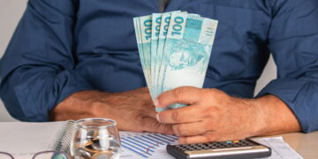 homem com notas de cem reais