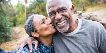 A beautiful senior African American Couple takes a selfie during their workout